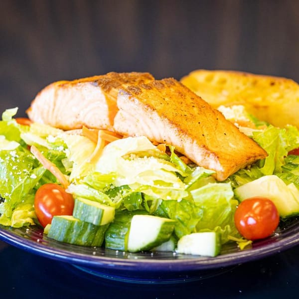PerKup Cafe's salmon salad with cherry tomatoes, cucumbers, and garlic bread.